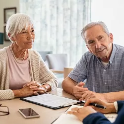 Retired Couple Talking To Their Financial Advisor
